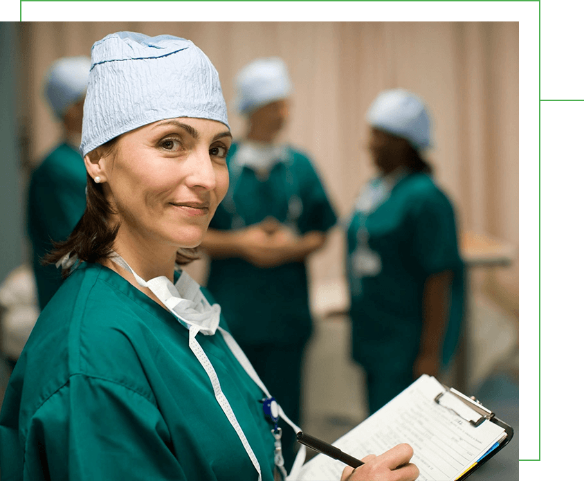 A woman in green scrubs holding a clipboard.